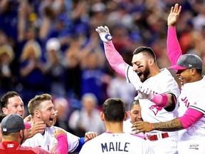 Toronto Blue Jays outfielder Kevin Pillar (second right) celebrates his game winning home run against the Seattle Mariners with teammates during ninth inning American League baseball action in Toronto, Sunday, May 14, 2017. THE CANADIAN PRESS/Frank Gunn