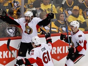 Ottawa Senators&#039; Bobby Ryan, left, celebrates with teammates Mark Stone (61) and Jean-Gabriel Pageau (44) after scoring the game-winning goal against the Pittsburgh Penguins during the overtime period of Game 1 of the Eastern Conference final in the NHL hockey Stanley Cup playoffs, Saturday, May 13, 2017, in Pittsburgh. Ottawa won 2-1 in overtime. (AP Photo/Gene J. Puskar)
