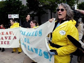 A small group of demonstrators protesting Canada&#039;s Trans Mountain Pipeline expansion chant as Canada Prime Minister Justin Trudeau leaves a hotel steps away following a meeting Thursday, May 18, 2017, in Seattle. Trudeau met with Washington state Gov. Jay Inslee to discuss trade, regional economic development, and climate. (AP Photo/Elaine Thompson)