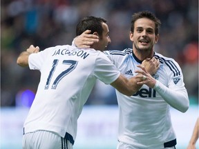 Vancouver Whitecaps' Octavio Rivero, centre, Andrew Jacobson, left, and Russell Teibert celebrate Rivero's goal against the Houston Dynamo during the second half of an MLS soccer game in Vancouver, B.C., in a May 28, 2016, file photo.