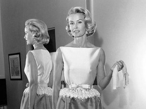 FILE - In this April 6, 1962 file photo, socialite-actress Dina Merrill models the gown she will wear at the Academy Awards presentation in Los Angeles. Merrill, the rebellious heiress who defied her super-rich parents to become an actress, died Monday, May 22, 2017, at age 93. (AP Photo/Harold P. Matosian, File)
