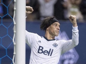 Vancouver Whtiecaps&#039; Christian Bolanos celebrates teammate Fredy Montero&#039;s goal against the Seattle Sounders during the second half of MLS soccer action in Vancouver, B.C. Friday, April 14, 2017. The Costa Rican international showed up in January with tendinitis in his right knee and missed all of the pre-season after what head coach Carl Robinson described as Bolanos taking too much time off over the winter. THE CANADIAN PRESS/Jonathan Hayward