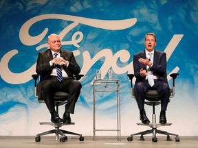 FILE - In this Monday, May 22, 2017, file photo, Bill Ford Jr., right, executive chairman of Ford Motor Company, introduces Jim Hackett as CEO, in Dearborn, Mich. Hackett and Ford spoke to The Associated Press about the carmaker&#039;s plans to transform itself under new leadership and fix recent quality problems. (AP Photo/Paul Sancya, File)