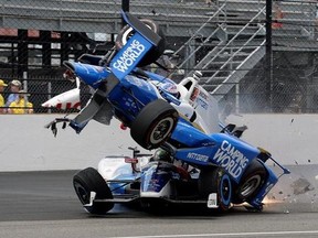 The car driven by Scott Dixon, of New Zealand, goes over the top of Jay Howard, of England, in the first turn during the running of the Indianapolis 500 auto race at Indianapolis Motor Speedway, Sunday, May 28, 2017, in Indianapolis. (AP Photo/Marty Seppala)