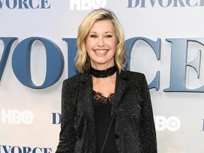 FILE - In this Oct. 4, 2016 file photo, actress and singer Olivia Newton-John attends the premiere of HBO&#039;s &ampquot;Divorce&ampquot; in New York. Newton-John says she has breast cancer and is canceling her June tour. The 68-year-old singer announced Tuesday, May 30, 2017, that she initially thought she was suffering from back pain, but learned it was ‚Äúbreast cancer that has metastasized to the sacrum.‚Äù (Photo by Andy Kropa/Invision/AP, File)