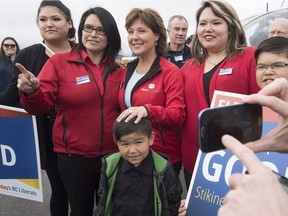 A reporter takes pictures with his smartphone as B.C. Liberal leader Christy Clark makes a campaign stop in Smithers, B.C., Friday, May 5, 2017.