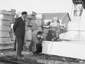 Alan Lomax (kneeling) prepares his recording equipment in Carrara, Italy (1954).