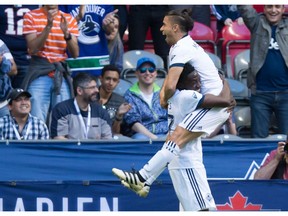 Vancouver Whitecaps' Alphonso Davies, left, and Nicolas Mezquida celebrate Davies' goal against the Montreal Impact during first half semifinal Canadian Championship soccer action in Vancouver, B.C., on Tuesday May 23, 2017.