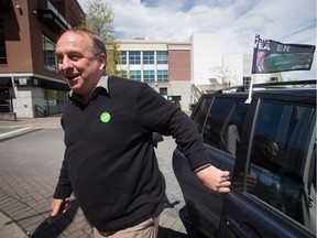 Green Party Leader Andrew Weaver gets out of a vehicle to stop to talk to reporters outside a campaign stop by NDP Leader John Horgan in Nanaimo, B.C., on Friday May 5, 2017. A provincial election will be held on Tuesday.