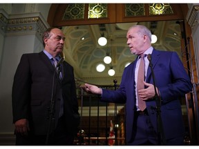 B.C. Green party leader Andrew Weaver and B.C. NDP Leader John Horgan, right, speak to reporters in Victoria on Monday afternoon after announcing they'll be working together to help form a minority government.