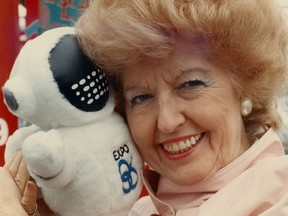 Legendary Social Credit cabinet minister Grace McCarthy poses with an Expo Ernie doll.