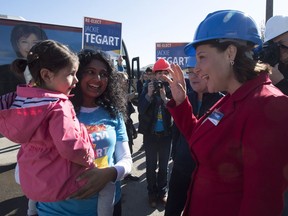 B.C. Liberal Leader Christy Clark greets a young supporter as she tours NMV Lumber in Merritt, B.C., Tuesday, May 2, 2017.