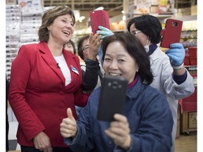 B.C. Liberal leader Christy Clark poses for a photo as she makes a campaign stop at a grocery store in Coquitlam on Sunday.