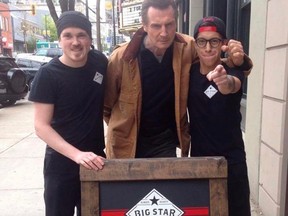 Liam Neeson poses with staff at Big Star Sandwiches in New Westminster.