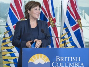 Premier Christy Clark talks to reporters at her office in Vancouver on Wednesday.