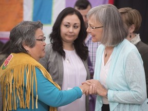 Chief Commissioner Marion Buller (right)greets Frances Neumann after she told a story about her murdered sister-in-law Mary Johns at the National Inquiry into Missing and Murdered Indigenous Women and Girls taking place in Whitehorse, Yukon, Tuesday, May 30, 2017.