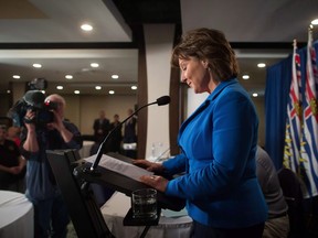 British Columbia Premier Christy Clark pauses to read her notes while addressing MLAs during a caucus meeting at a hotel in Vancouver on May 16, 2017.