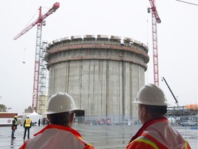 Construction workers look on at the Fortis B.C. Tilbury LNG expansion project in Delta in November 2015.