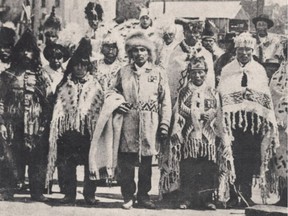 Chief Joe Capilano (centre, holding blanket) with a delegation of chiefs at the North Vancouver ferry wharf in 1906.