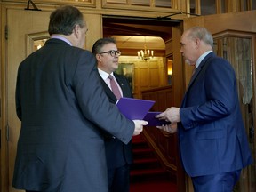 B.C. NDP leader John Horgan and B.C. Green party leader Andrew Weaver arrive at Government House to drop of a signed document by 44 MLAs to Director of the House Jeremy Brownridge which shows theres an agreement between the two parties in Victoria, B.C., on Wednesday, May 31, 2017.