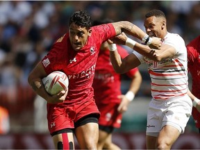 England's Dan Norton and Canada's Mike Fuailefau, left, on day two of the London Sevens.