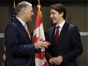 Canada Prime Minister Justin Trudeau, right, and Washington state Gov. Jay Inslee chat as they pose for photographers before a meeting Thursday, May 18, 2017, in Seattle. The two were to discuss trade, regional economic development, and climate.