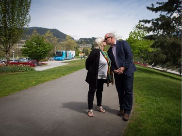 B.C. NDP Leader John Horgan and his wife Ellie kiss while waiting after bringing voters to a polling station to vote in the provincial election, in Coqutilam, B.C., on Tuesday May 9, 2017.