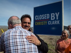 Local NDP candidate Harry Lali, back, and NDP Leader John Horgan embrace during a campaign stop outside the closed Tolko Industries Nicola Valley sawmill in Merritt on May 2. After losing the election, Lali is blaming his own part and his leader.