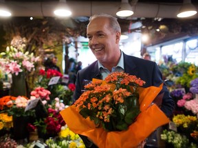 NDP Leader John Horgan holds orange potted flowers, bought during a campaign stop at Granville Island on May 7, 2017. "This is undeniably an NDP plant," he joked, a reference to B.C. Liberal attempts to inaccurately portray a negative encounter between voter Linda Higgins and Liberal Leader Christy Clark earlier in the campaign as part of a planted attack by the NDP on the Liberals.