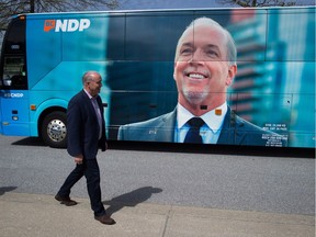 B.C. NDP Leader John Horgan walks to speak to reporters while bringing voters to a polling station to vote in the provincial election, in Coqutilam, B.C., on Tuesday May 9, 2017.