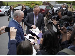 B.C. NDP Leader John Horgan and B.C. Green party Leader Andrew Weaver, right, speak to media after arriving at Government House in Victoria on Wednesday, May 31, 2017.