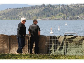 Cedric Hanson, left, of Rossland and Robin Cardew, of Vernon look over the gabion barriers that have been set up at Strathcona Park near Kelowna General Hospital on Wednesday.