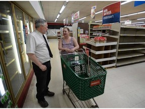 Store owner Bob Bromley talks to longtime customer Mary Cook at Bromley's Market in Sumas, Wash. The grocery store, the only one in Sumas, has been owned by the Bromley family since 1960 but is expected to close Wednesday.