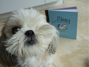 Missy the One-Eyed Dog is pictured with her book.