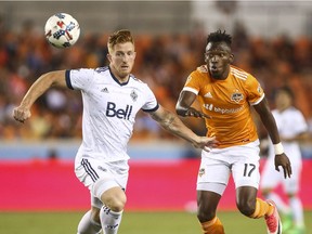 Vancouver Whitecaps defender Tim Parker (left) vies for the ball with Houston Dynamo forward Alberth Elis during their Major League Soccer game on Friday at BBVA Compass Stadium in Houston, Texas. The host Dynamo won 2-1.