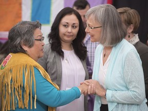 Chief Commissioner Marion Buller (right) greets Frances Neumann after she told a story about her murdered sister-in-law Mary Johns at the National Inquiry into Missing and Murdered Indigenous Women and Girls taking place in Whitehorse, Yukon, Tuesday, May 30, 2017.