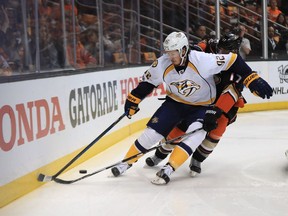 Ryan Johansen, front, of the Nashville Predators protects the puck from Ryan Kesler of the Ducks during Game 2 of the Western Conference final at the Honda Center on Sunday in Anaheim.