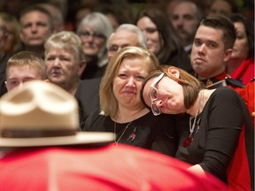 FILE PHOTO RCMP Constable David Wynn's sons, from left, Nathan Wynn, Matthew Wynn, wife Shelly MacInnis-Wynn and sister Lindsay Sarty sit in front of David's casket during the funeral procession for slain RCMP Constable David Wynn, in St. Albert, Alta., on Monday, January 26, 2015. Wynn died four days after he and Auxiliary Constable Derek Bond were shot by Shawn Rehn in St. Albert, Alta, on Saturday, January 17, 2015.