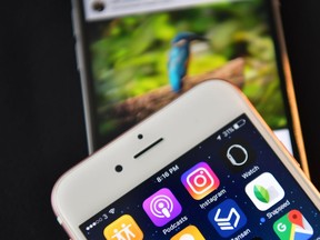 LONDON, ENGLAND - AUGUST 03:  The Instagram app logo is displayed next to an "Instagrammed" image on another iPhone on August 3, 2016 in London, England.