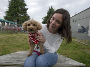 Richmond Animal Protection Society manager Julie Desgroseillers with Donut, the six-year-old poodle found Sunday locked inside a suitcase in bushes in Richmond. ‘They obviously put the poor creature in there to die,’ Graham Barrett said of the poodle that he rescued.