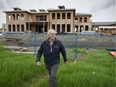 Harold Steves, a Richmond councillor and farmer,  in front of a 'mega house' under construction on farmland in Richmond. A rapidly growing trend has people buying farms, building a huge farmhouse, then doing just enough farming to qualify for farm tax breaks. Farmland prices in Metro Vancouver have soared out of the reach of most farmers because of the trend, which is leaving much arable land out of production in the region.