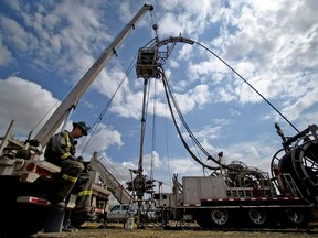 Darryl Penner, an employee of TRICAN Well Service, takes a break outside of fracking operation at a site near Rosebud, Alberta.