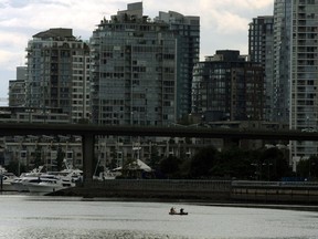 Paddlers guide their canoe through the eastern section of False Creek. It's no surprise that our waters are sewage-filled, a reader says. Most non-boaters don't realize that many boats, especially older ones, don't have a sewage holding tank.