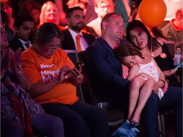 A young girl sleeps as the clock nears midnight as NDP supporters watch results at NDP election night headquarters in Vancouver, B.C., on Tuesday May 9, 2017.