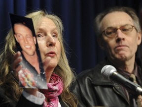 FILE PHOTO Integrated Homicide Investigation Team media briefing in Surrey, B.C., Friday February 13, 2009. Mary Barber holds up photograph of her son Jonathan, who was killed in a gang shooting. Father Michael (R).