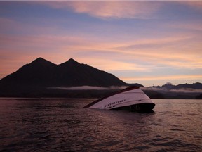 The bow of the Leviathan II, a whale-watching boat owned by Jamie's Whaling Station carrying 24 passengers and three crew members that capsized on Sunday, is seen near Vargas Island as it waits to be towed into Tofino, B.C., Tuesday, October 27, 2015 for inspection.