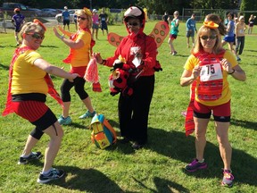 Brenda Kerslake, left, Yvonne Repin and Debbie Elliott — the Three Amigo-ettes — warm up with the Ladybug Lady before Sunday's 20th annual Vistas Run and Family Walk in Maple Ridge.