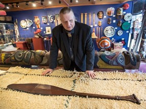 Thomas Stark with a decorated Coast Salish paddle.