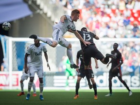 Vancouver Whitecaps' Tim Parker, left, and D.C. United's Lamar Neagle vie for the ball during the first half of an MLS soccer game in Vancouver, B.C., on Saturday May 27, 2017.