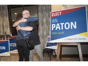 Liberal candidate Ian Paton hugs his daughter Tuesday after winning Delta South.